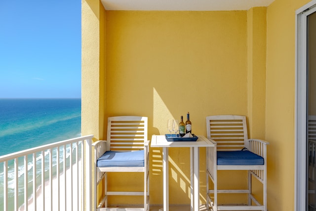 balcony with a water view and a beach view