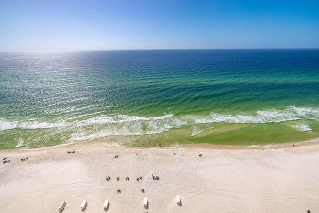 drone / aerial view with a water view and a beach view