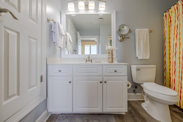 bathroom with vanity, toilet, hardwood / wood-style flooring, and a shower with curtain