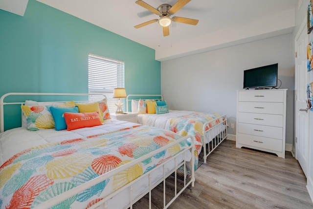 bedroom with ceiling fan and light hardwood / wood-style flooring