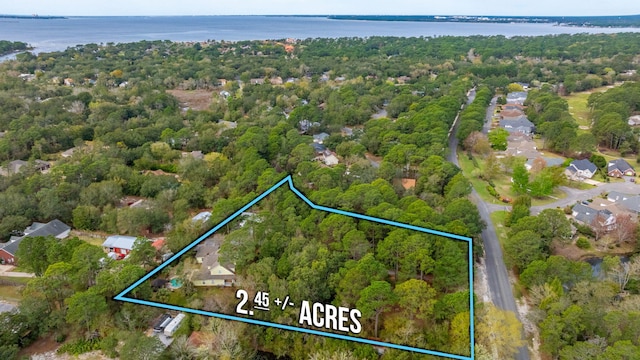 aerial view featuring a water view and a view of trees