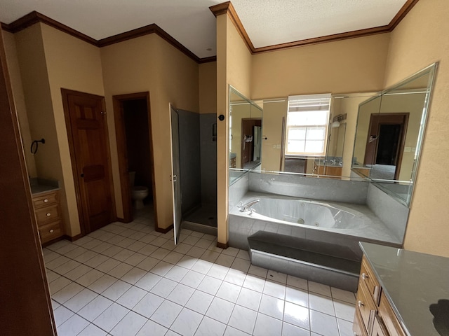 bathroom featuring toilet, ornamental molding, vanity, tile patterned flooring, and a tub with jets