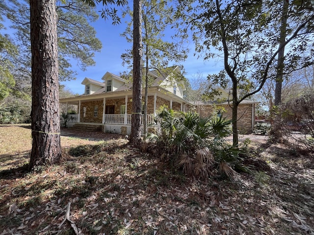 view of side of home with covered porch