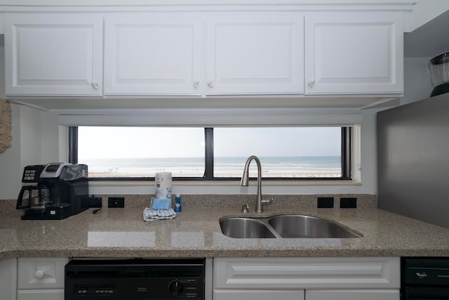 kitchen featuring dishwasher, white cabinets, and a healthy amount of sunlight