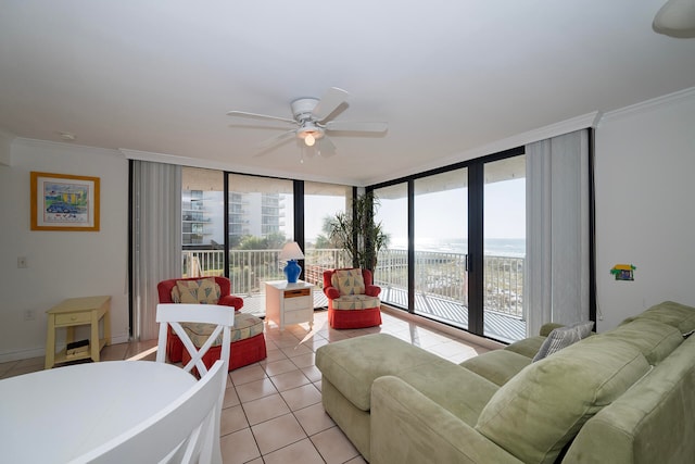 tiled living room featuring a water view, ceiling fan, ornamental molding, and floor to ceiling windows