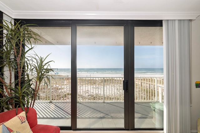 entryway featuring french doors, a water view, and a view of the beach