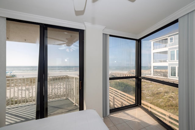 bedroom featuring a wall of windows, ornamental molding, a water view, and light tile patterned floors