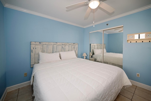 tiled bedroom featuring a closet, ceiling fan, and ornamental molding