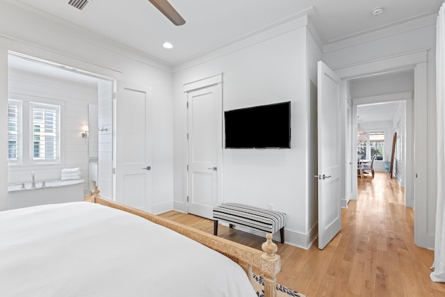 bedroom featuring multiple windows, light hardwood / wood-style floors, ceiling fan, and crown molding