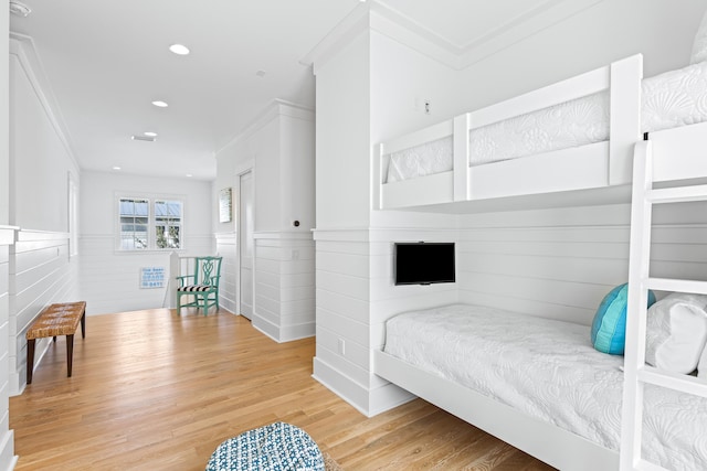 bedroom featuring hardwood / wood-style floors and crown molding