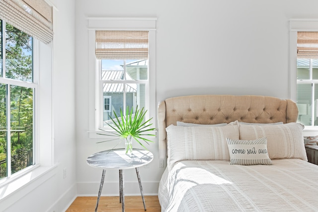 bedroom featuring hardwood / wood-style flooring and multiple windows