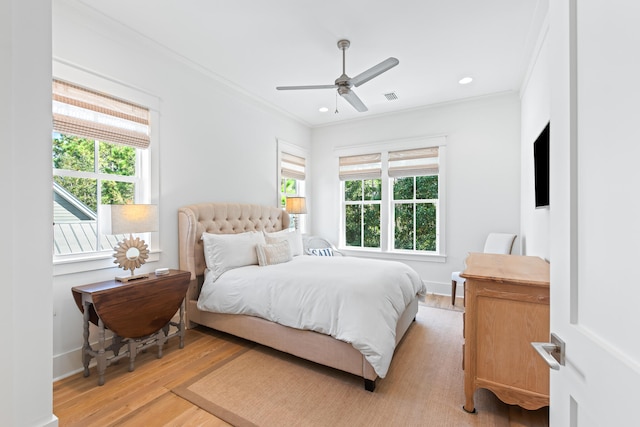 bedroom with ornamental molding, light hardwood / wood-style floors, and ceiling fan