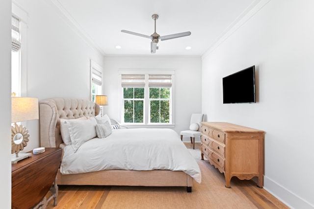 bedroom featuring ceiling fan, light hardwood / wood-style flooring, and ornamental molding