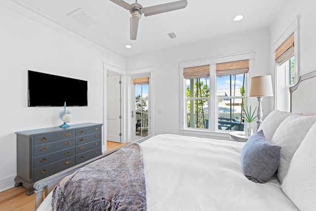 bedroom with access to outside, multiple windows, ceiling fan, and light wood-type flooring