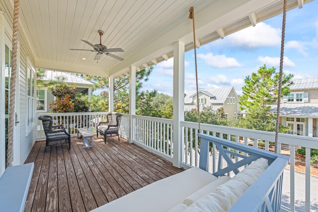 wooden deck with ceiling fan and an outdoor living space