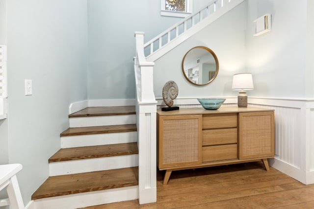 staircase with hardwood / wood-style flooring