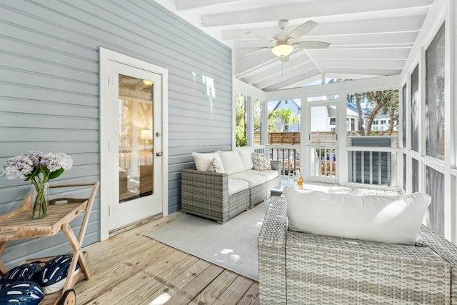 sunroom featuring ceiling fan and vaulted ceiling with beams