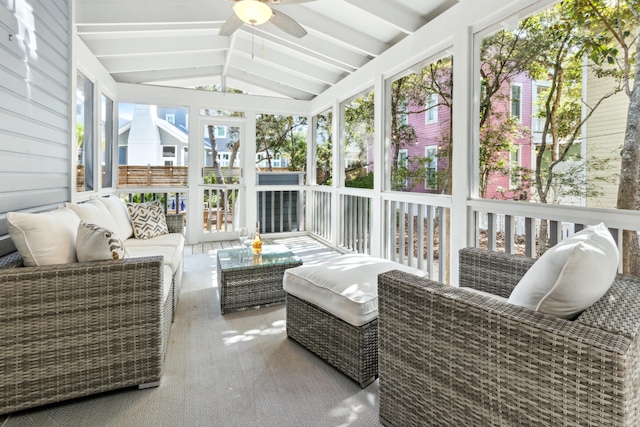 sunroom / solarium featuring ceiling fan and vaulted ceiling with beams