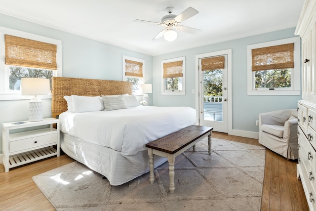 bedroom featuring access to exterior, light hardwood / wood-style floors, and ceiling fan