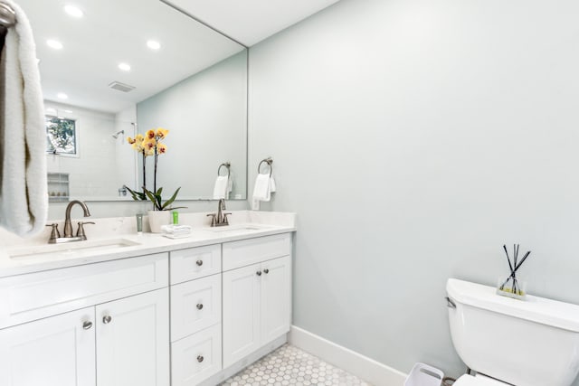 bathroom featuring vanity, a shower, toilet, and tile patterned flooring