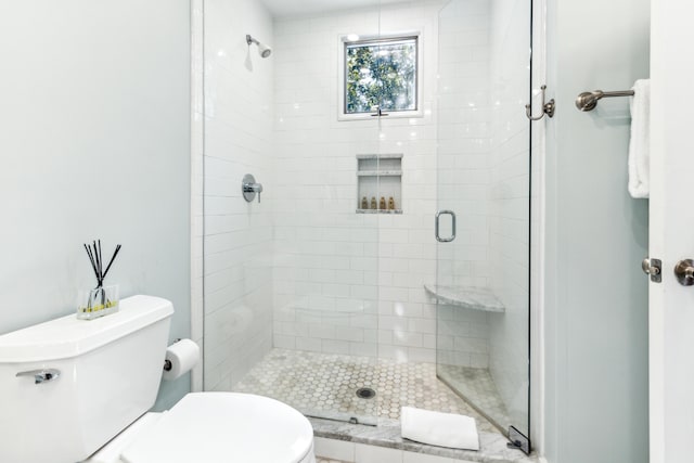 bathroom featuring toilet and an enclosed shower