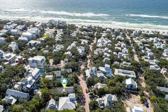 drone / aerial view with a water view and a beach view