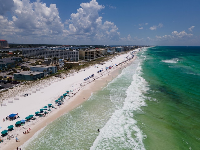 birds eye view of property featuring a water view and a beach view