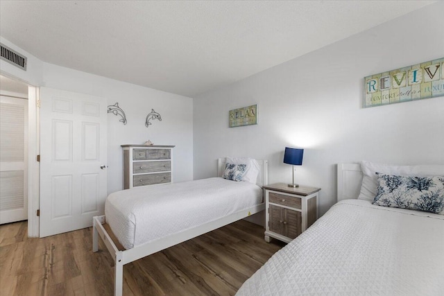 bedroom with dark wood-type flooring