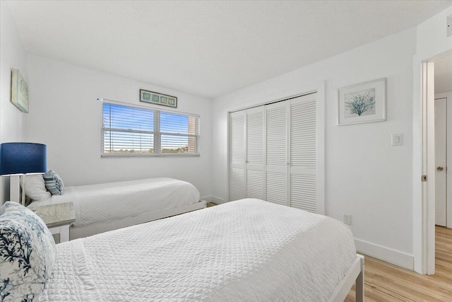 bedroom with a closet and light wood-type flooring