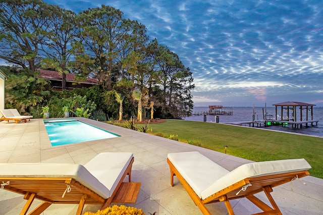 view of pool featuring a water view, a gazebo, a patio, and a lawn