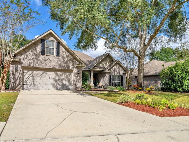 view of front of property with a garage and a front yard