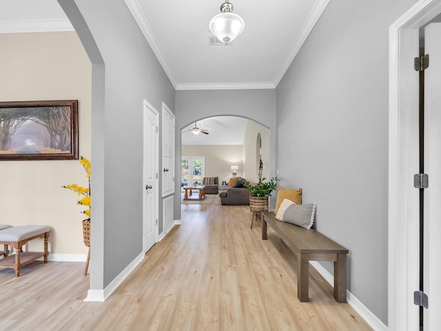 hall featuring light wood-type flooring and crown molding