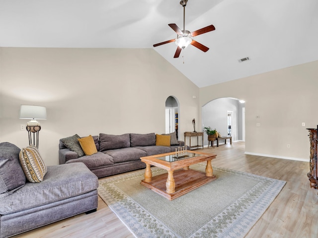 living room featuring ceiling fan, high vaulted ceiling, and light hardwood / wood-style flooring