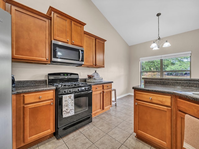 kitchen with appliances with stainless steel finishes, light tile patterned floors, pendant lighting, an inviting chandelier, and lofted ceiling