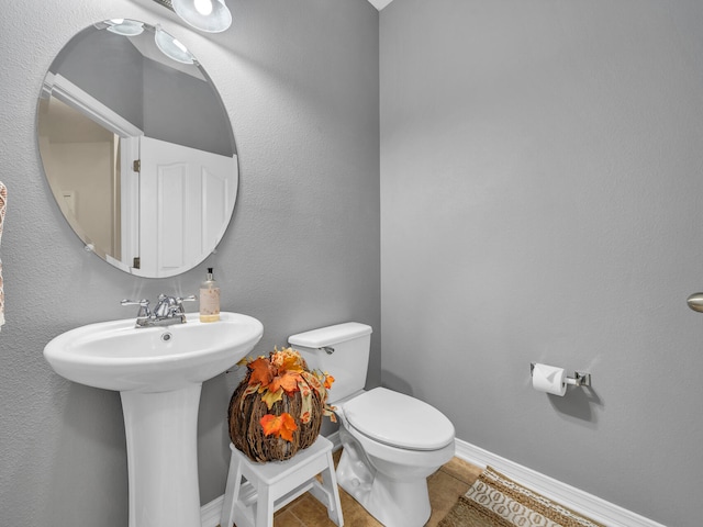 bathroom featuring sink, tile patterned flooring, and toilet