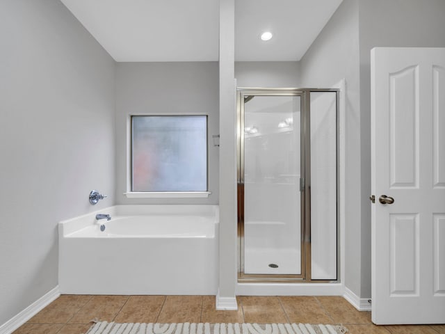 bathroom featuring tile patterned floors and independent shower and bath