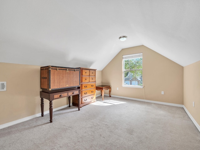 additional living space featuring carpet flooring and lofted ceiling