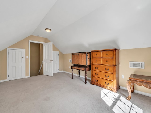 bonus room featuring light carpet and lofted ceiling