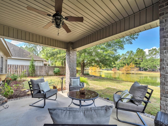 view of patio with ceiling fan and a water view