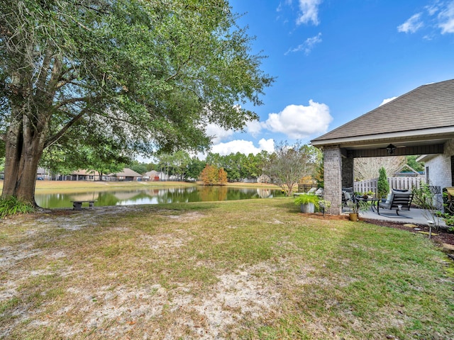 view of yard featuring a water view and a patio