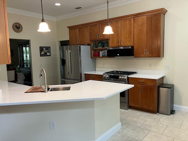 kitchen with appliances with stainless steel finishes, ornamental molding, sink, and pendant lighting