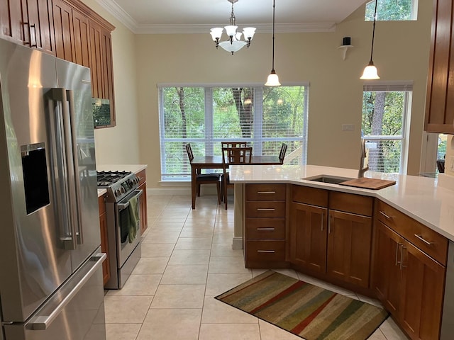 kitchen with hanging light fixtures, stainless steel appliances, and plenty of natural light