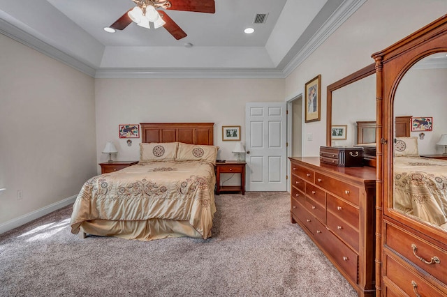 carpeted bedroom with ceiling fan, ornamental molding, and a tray ceiling