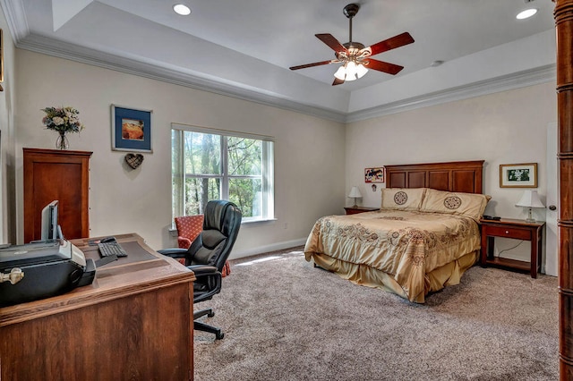 bedroom featuring light carpet, ornamental molding, a tray ceiling, and ceiling fan