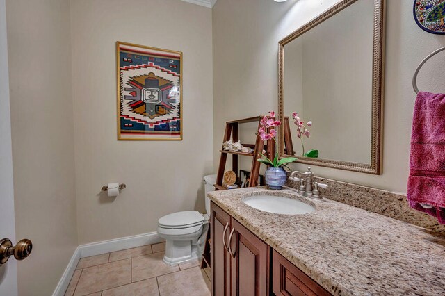 bathroom with vanity, toilet, and tile patterned flooring