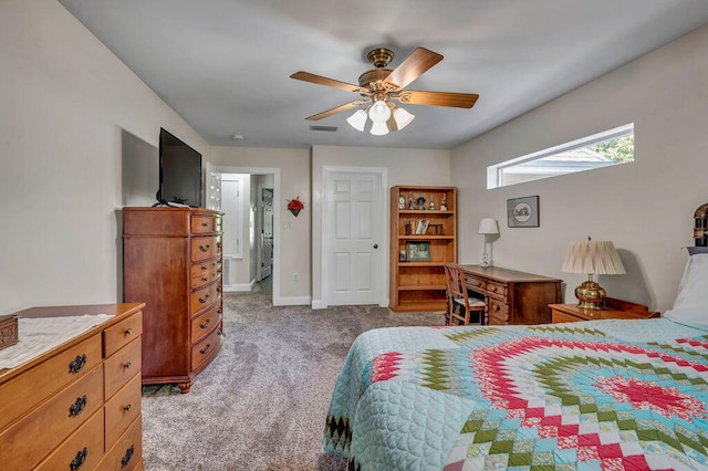 carpeted bedroom featuring ceiling fan and a skylight