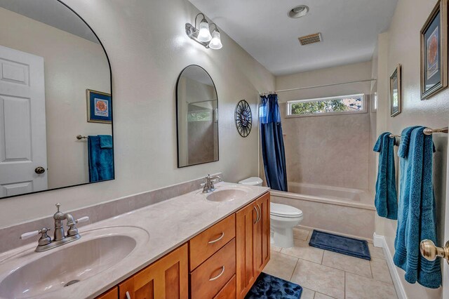 full bathroom with vanity, shower / bath combination with curtain, toilet, and tile patterned flooring