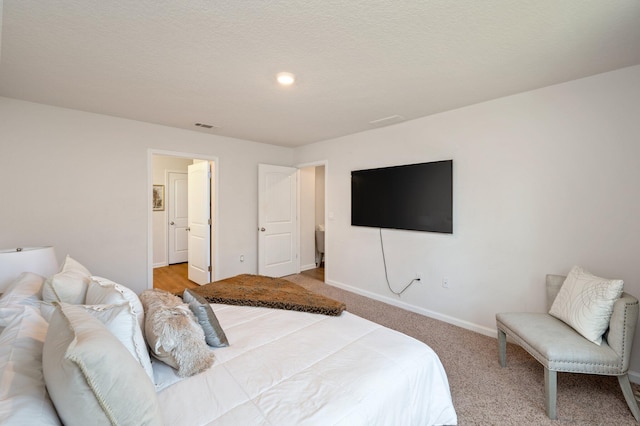 bedroom with carpet and a textured ceiling