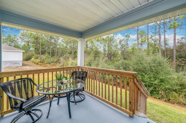 wooden deck with a lawn