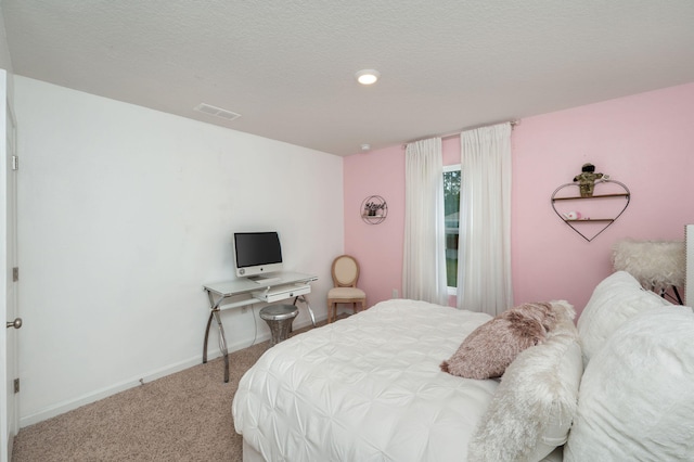 bedroom with a textured ceiling and carpet flooring